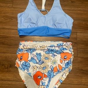 Women’s boutique swimsuit. Blue, orange, white floralSize large.NEVER been worn